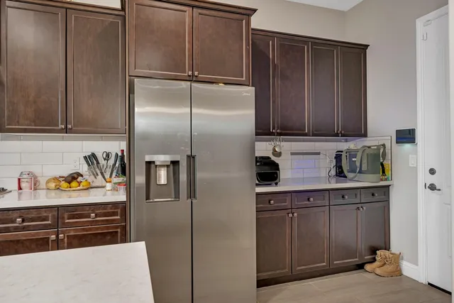 a bed sitting in a spacious bedroom next to a window