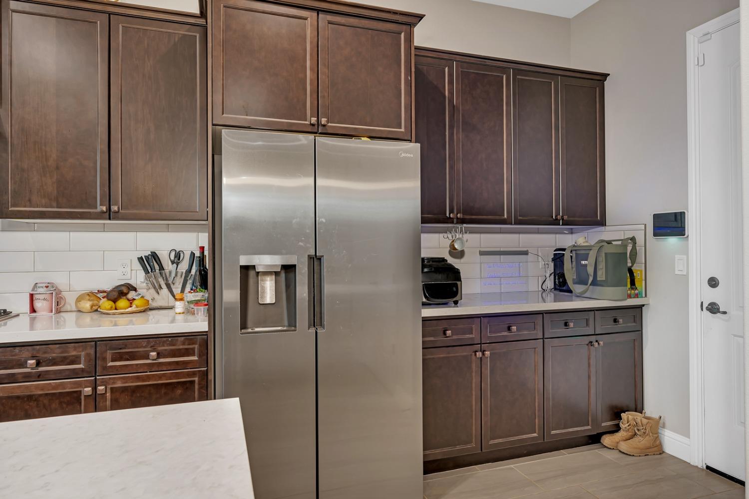 1053 Beaver Pond Loop Madera, CA 93636 - Photo 20 of 81 a kitchen with stainless steel appliances granite countertop a refrigerator and a sink