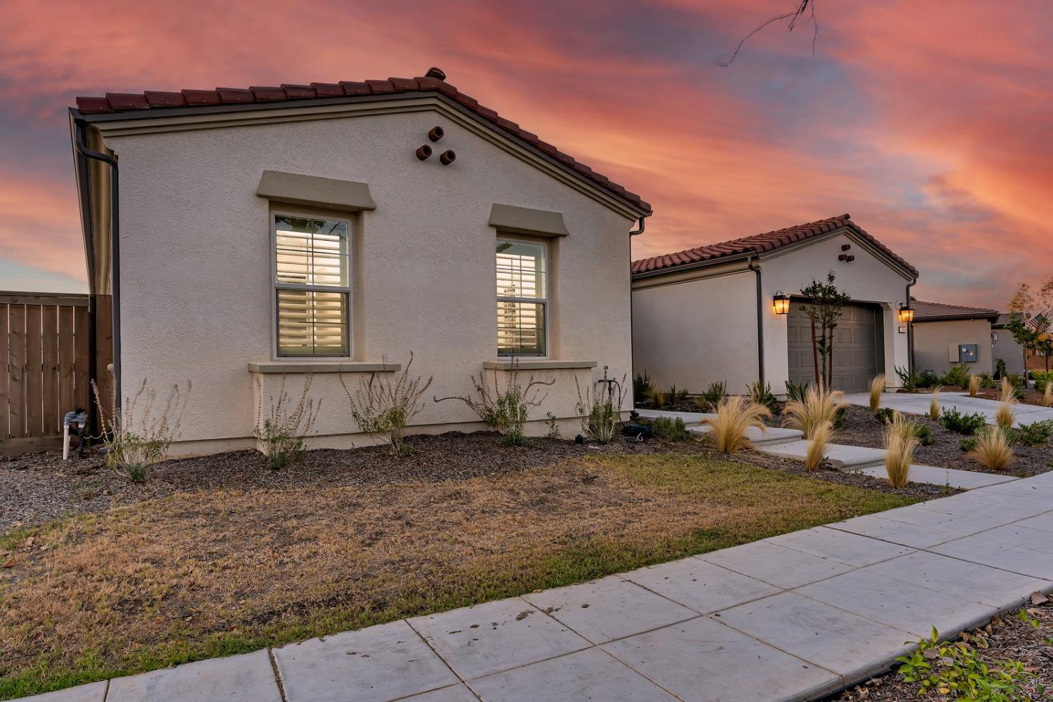 1053 Beaver Pond Loop Madera, CA 93636 - Photo 2 of 81 a front view of a house with a yard