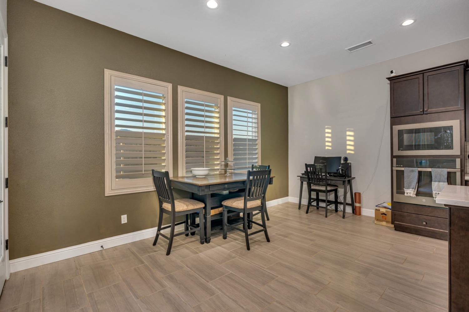 1053 Beaver Pond Loop Madera, CA 93636 - Photo 23 of 81 a dining room with furniture and wooden floor