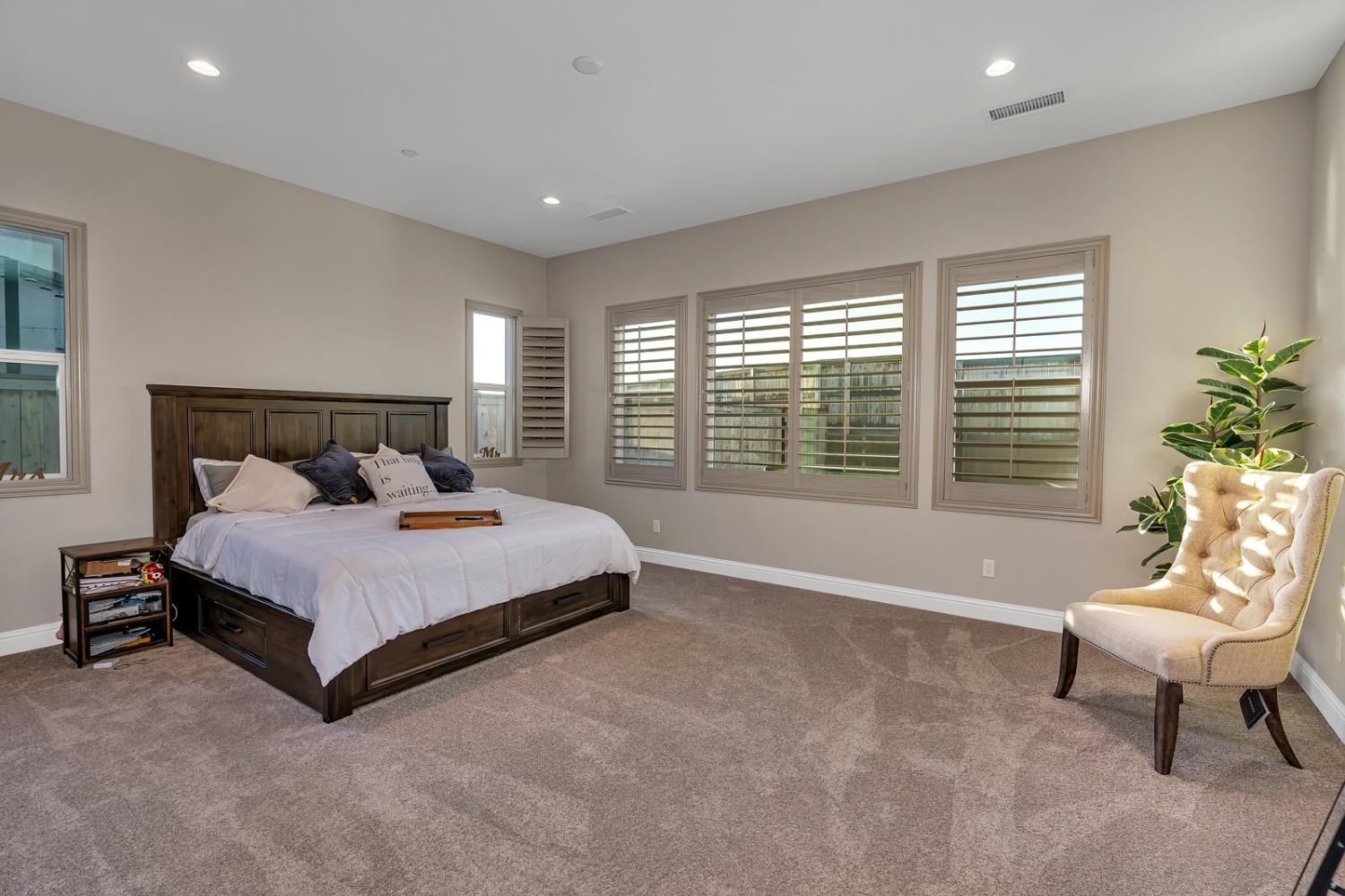 1053 Beaver Pond Loop Madera, CA 93636 - Photo 26 of 81 a bedroom with a bed and a couch