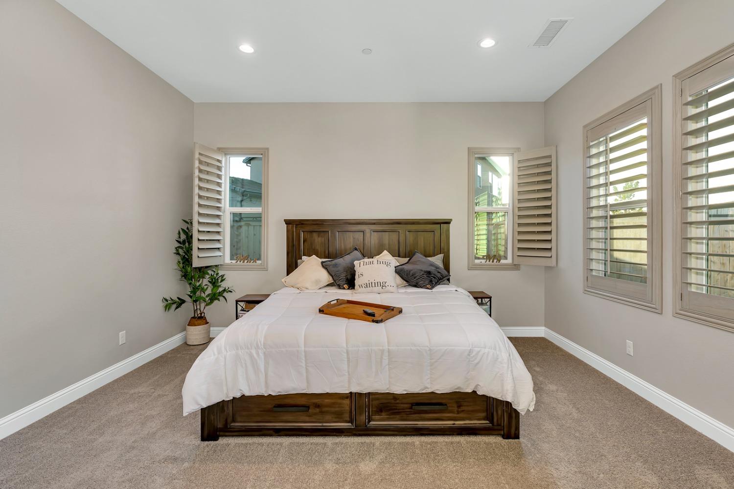 1053 Beaver Pond Loop Madera, CA 93636 - Photo 27 of 81 a bed sitting in a spacious bedroom next to a window