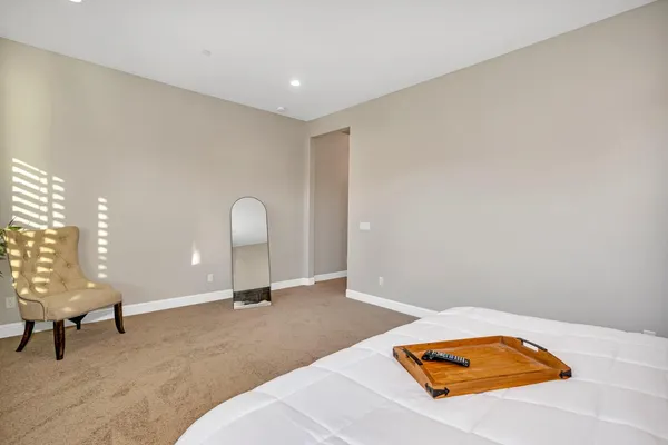 a bedroom with a bed and a mirror