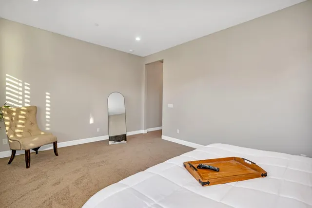 a bedroom with a bed and a mirror