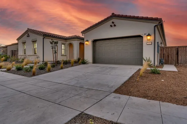 a view of a dining room with furniture and a chandelier