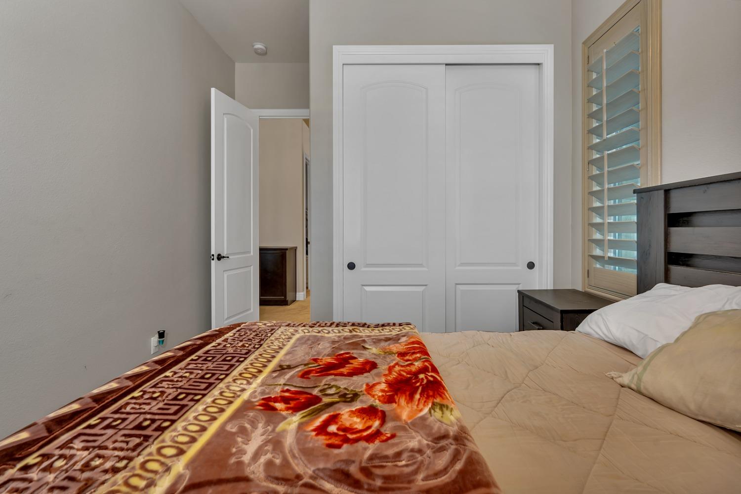 1053 Beaver Pond Loop Madera, CA 93636 - Photo 44 of 81 a bedroom with a bed and a window