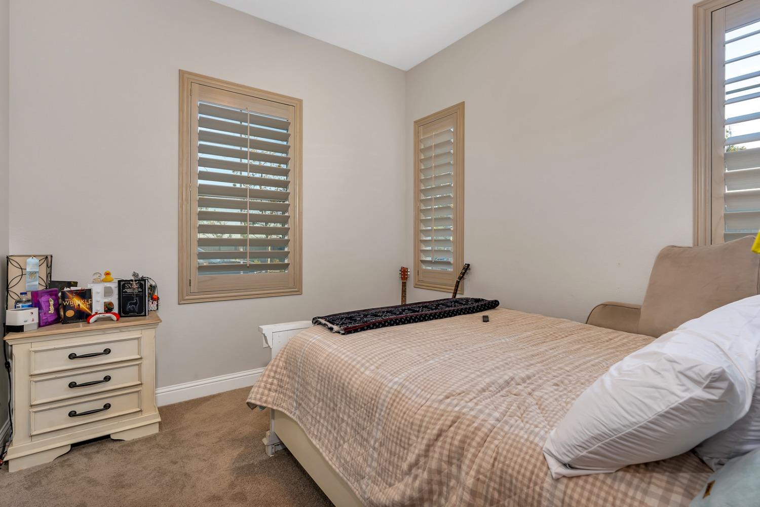 1053 Beaver Pond Loop Madera, CA 93636 - Photo 46 of 81 a bedroom with a bed and a window