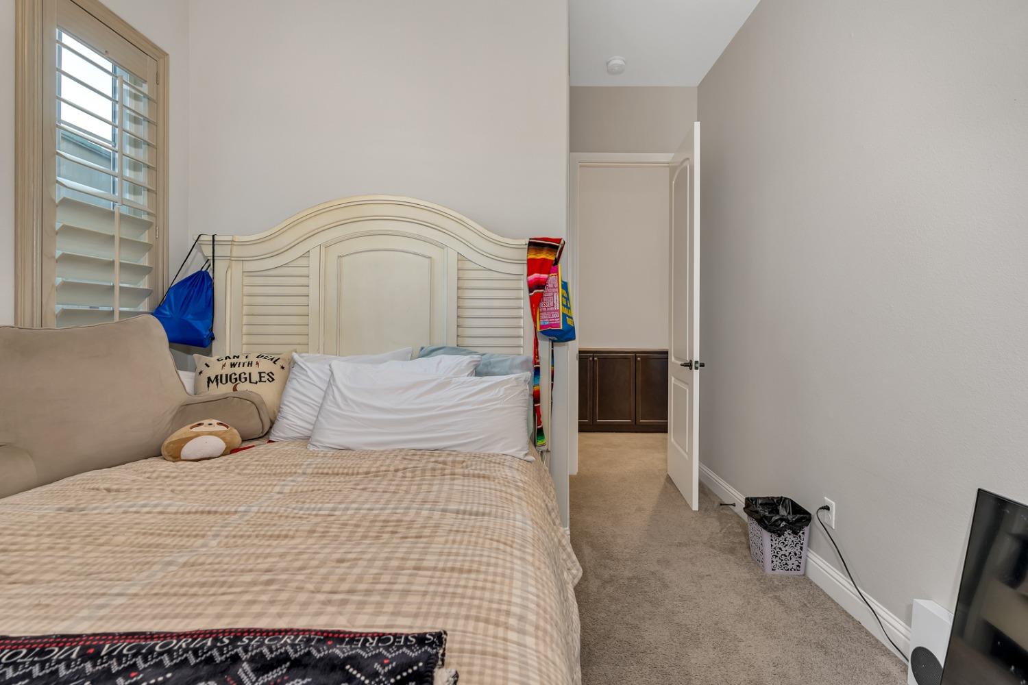 1053 Beaver Pond Loop Madera, CA 93636 - Photo 47 of 81 a bedroom with a bed and a window