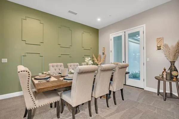 a living room with furniture and a large mirror