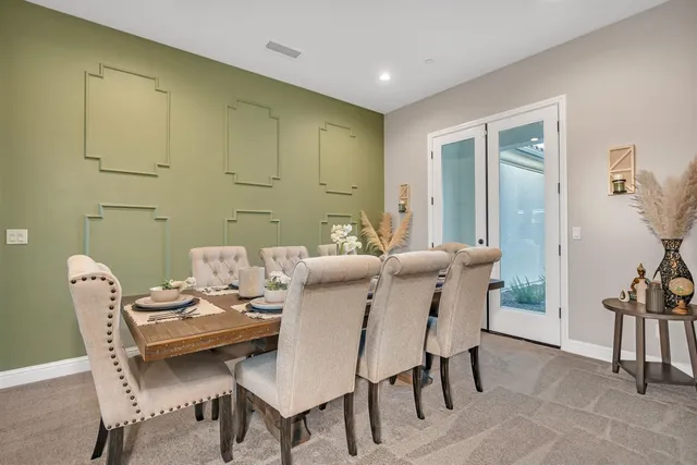 a living room with furniture and a large mirror
