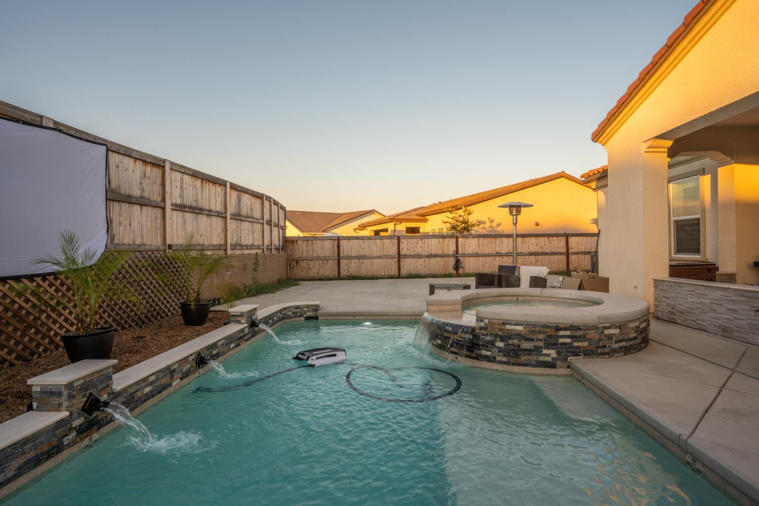 1053 Beaver Pond Loop Madera, CA 93636 - Photo 63 of 81 a living room with furniture and a floor to ceiling window