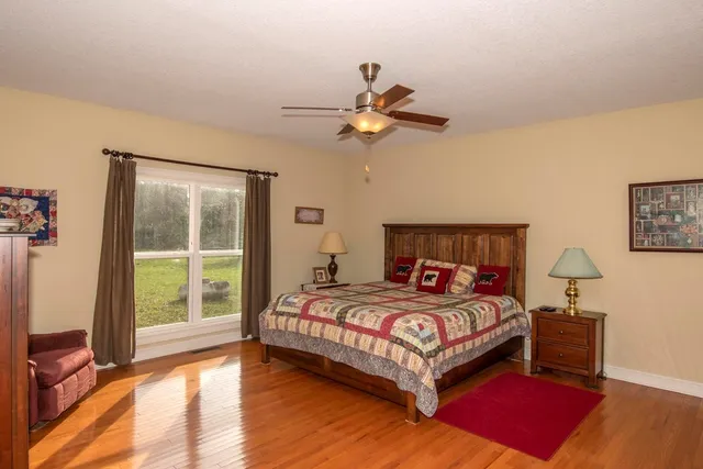 a bedroom with a bed and a large window