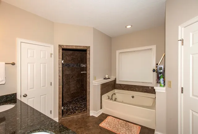 a view of bathroom with a tub shower and a sink