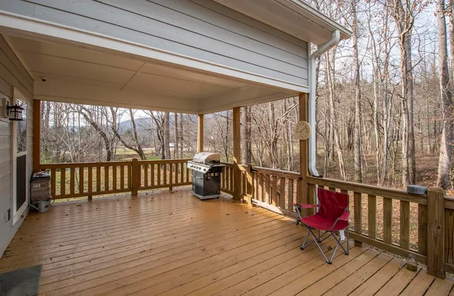 a view of a balcony with chairs and wooden floor