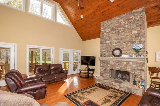 a living room with furniture a fireplace and a flat screen tv