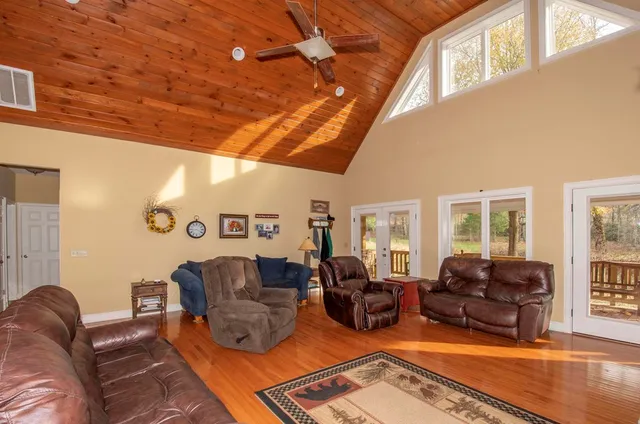a living room with furniture ceiling fan and a rug