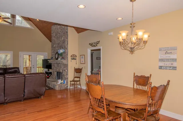 a view of a dining room with furniture wooden floor and chandelier