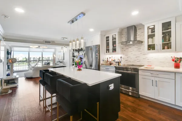 a kitchen with stainless steel appliances kitchen island granite countertop a sink and cabinets