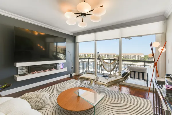 a living room with a floor to ceiling window and a flat screen tv