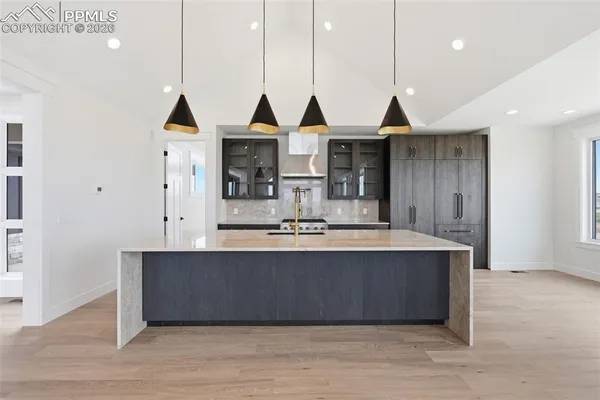 a kitchen with stainless steel appliances granite countertop a sink a oven and a refrigerator