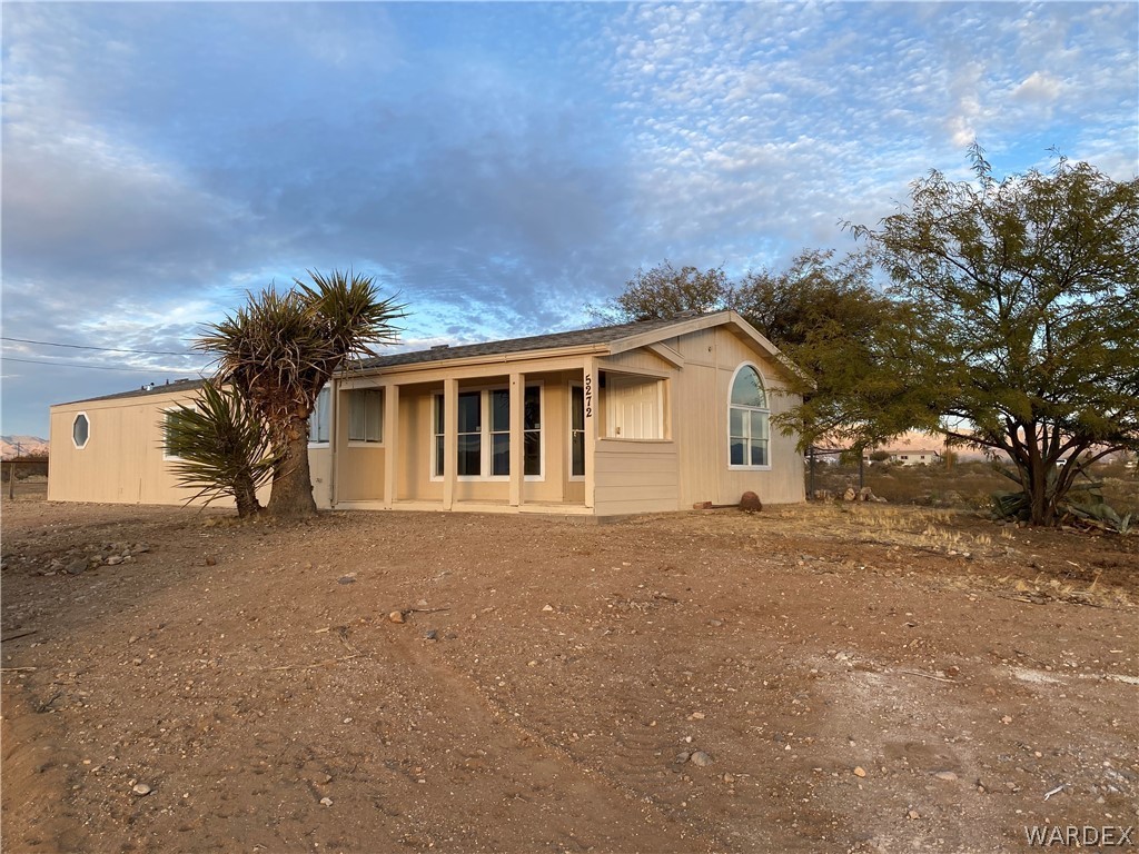 5272 Cove Road Golden Valley, AZ 86413 - Photo 1 of 24 a view of a house with a yard and garage