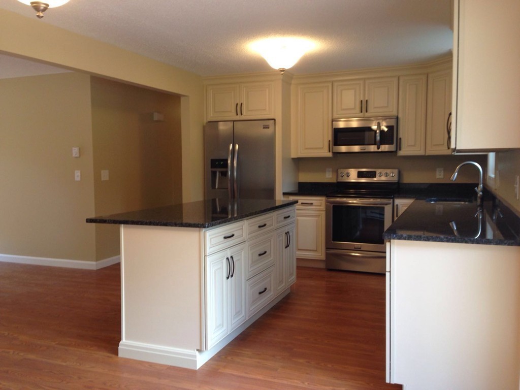 132 Benjamin Road Shirley, MA 01464 - Photo 2 of 9 a kitchen with stainless steel appliances a refrigerator stove and sink