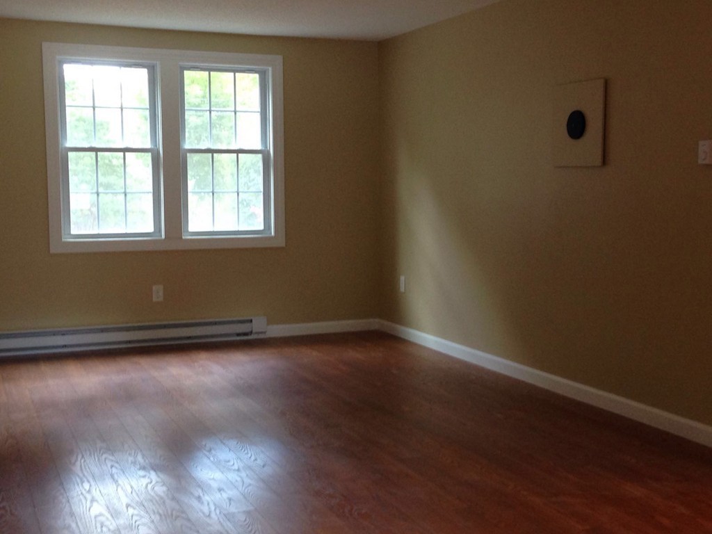 132 Benjamin Road Shirley, MA 01464 - Photo 5 of 9 an empty room with wooden floor and windows