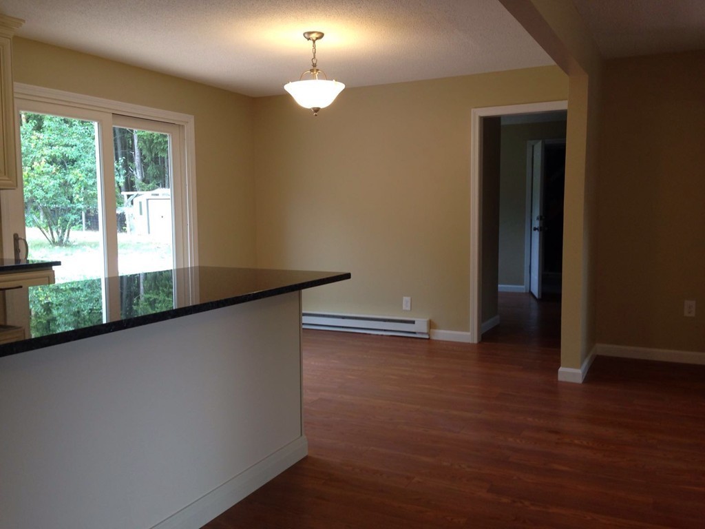 132 Benjamin Road Shirley, MA 01464 - Photo 9 of 9 a view of empty room with wooden floor and fan