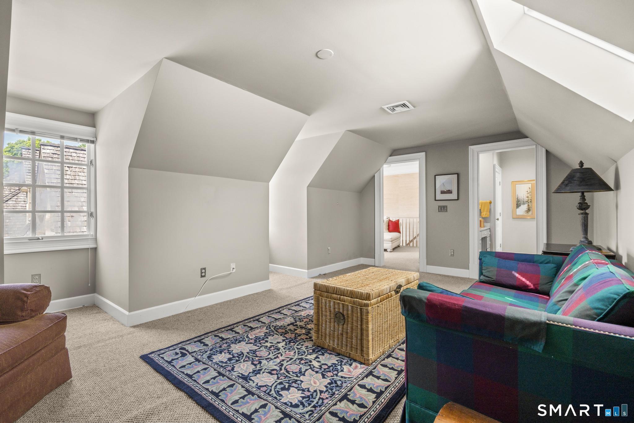 130 Stillson Road, Unit 130 Fairfield, CT 06825 - Photo 25 of 38 Third Bedroom on Second Level is spacious and currently staged as a den. Features ensuite jack-and-jill bathroom and walk-in-closet
