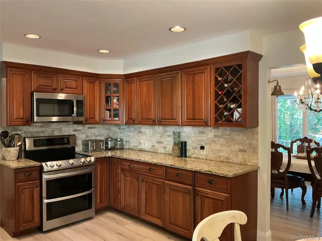 a kitchen with stainless steel appliances granite countertop a stove and a sink