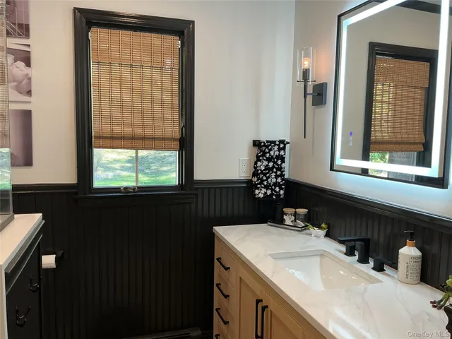 a bathroom with a sink and a window