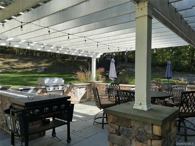 a view of a backyard with plants and patio