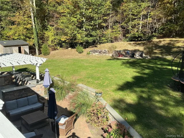 a view of street with wooden fence and trees