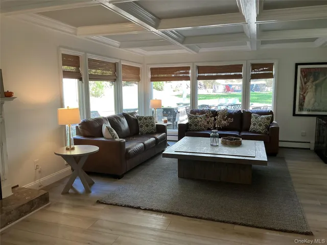 a living room with furniture and large windows