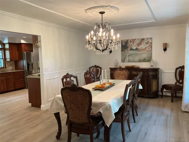 a view of a dining room with furniture wooden floor and chandelier