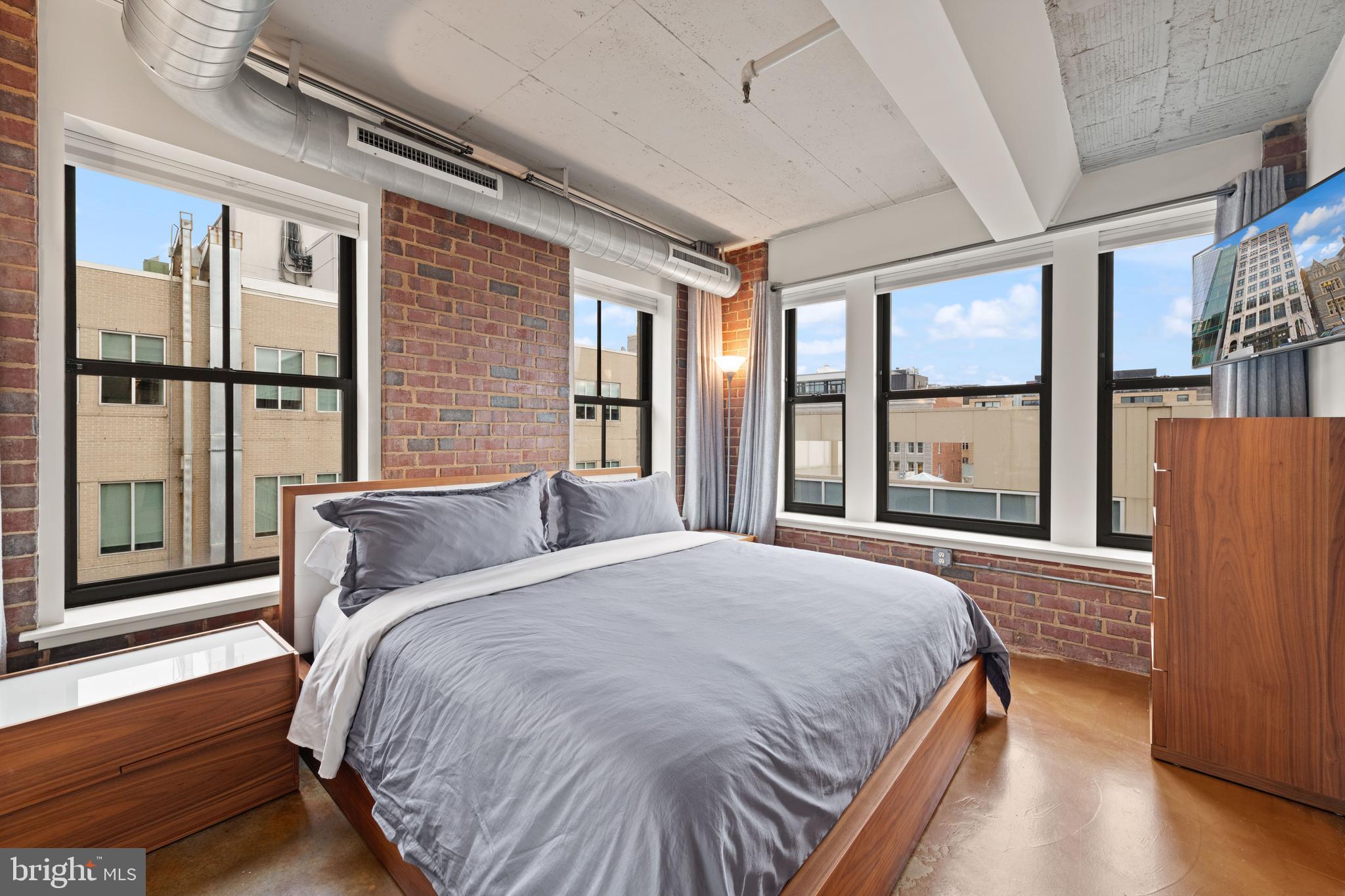 916 G St. Northwest, Unit 903 Washington, DC 20001 - Photo 17 of 65 a bedroom with a large bed and a large window