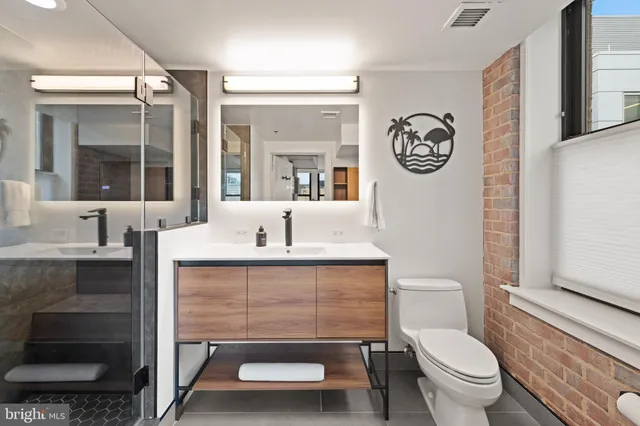 a spacious bedroom with a large bed and two windows