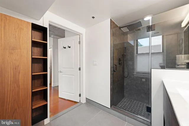 a bedroom with a bed and glass door