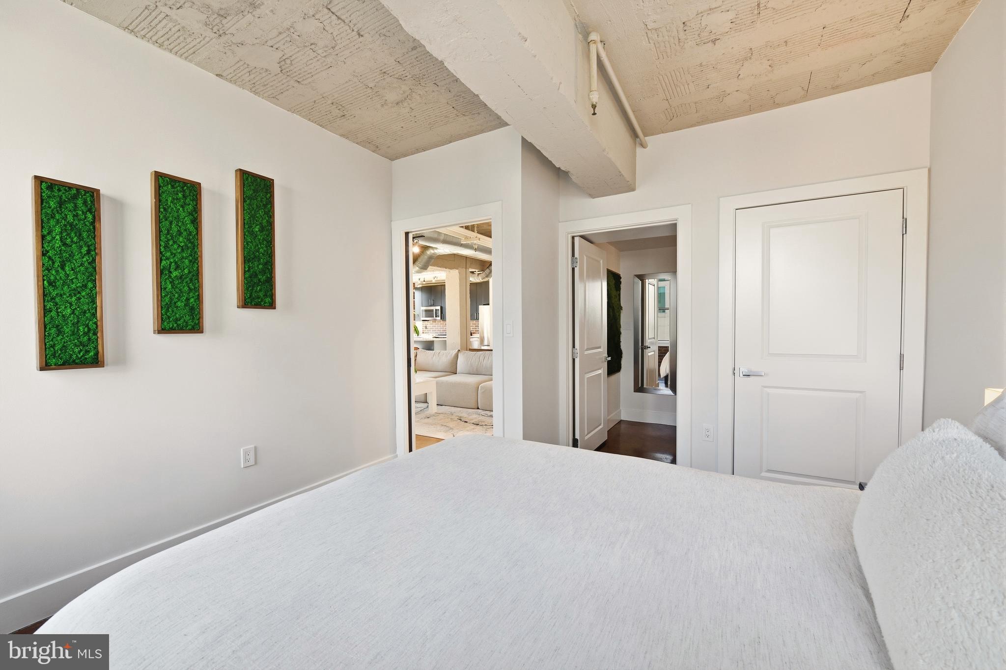 916 G St. Northwest, Unit 903 Washington, DC 20001 - Photo 30 of 65 a bedroom with a bed and glass door