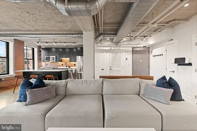 a living room with furniture and a clock
