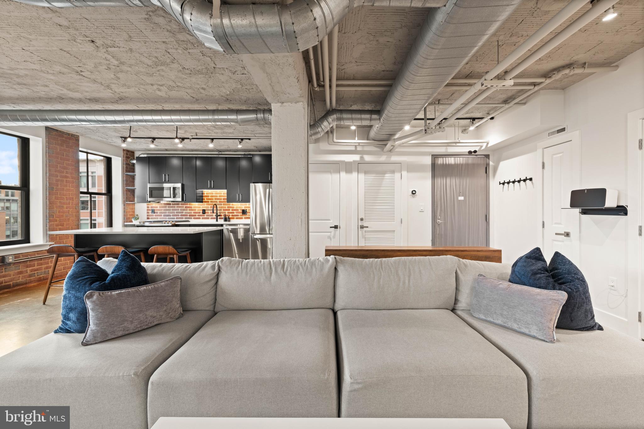 916 G St. Northwest, Unit 903 Washington, DC 20001 - Photo 4 of 65 a living room with furniture and a large window
