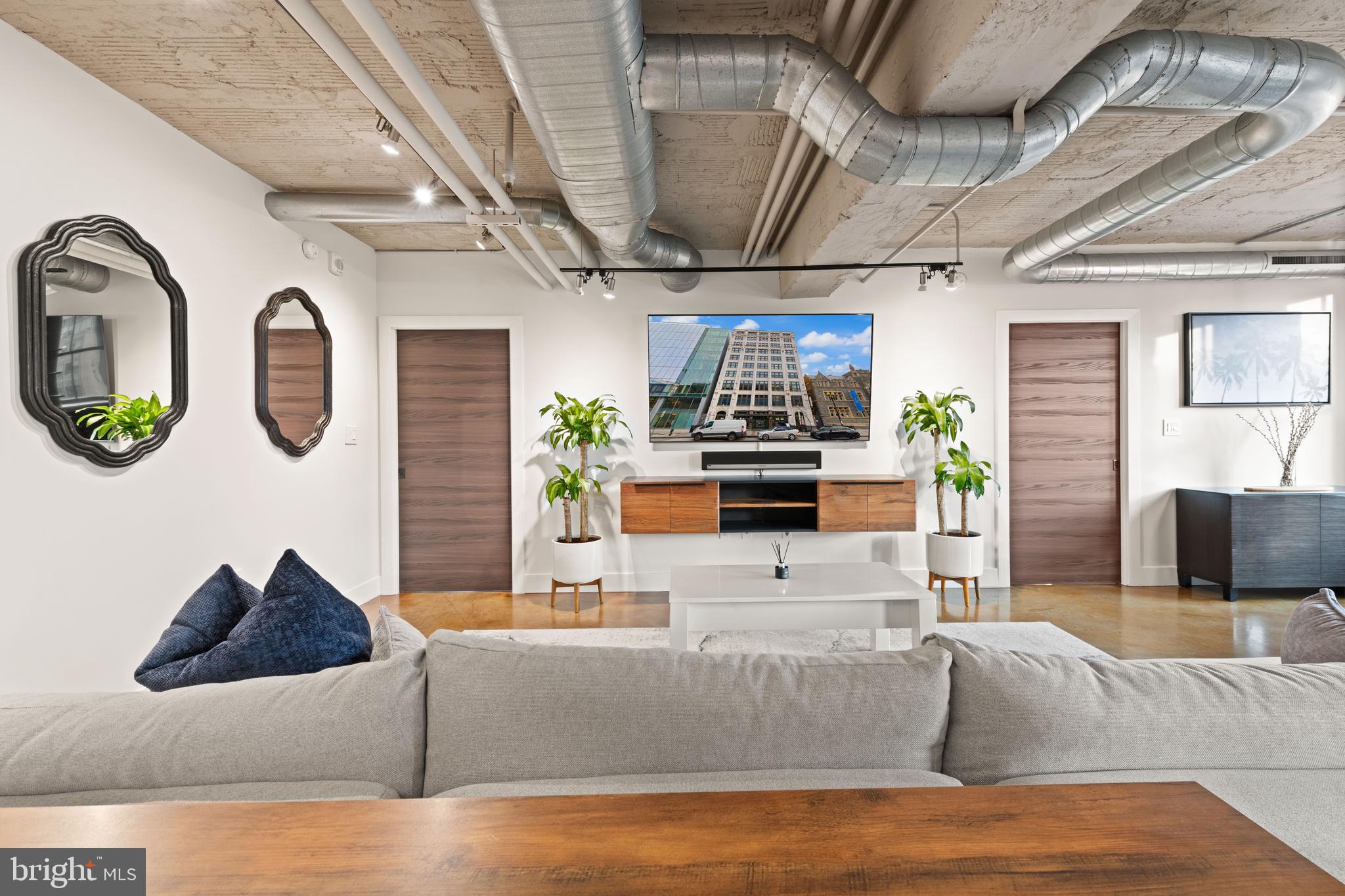 916 G St. Northwest, Unit 903 Washington, DC 20001 - Photo 5 of 65 a living room with furniture kitchen view and a chandelier