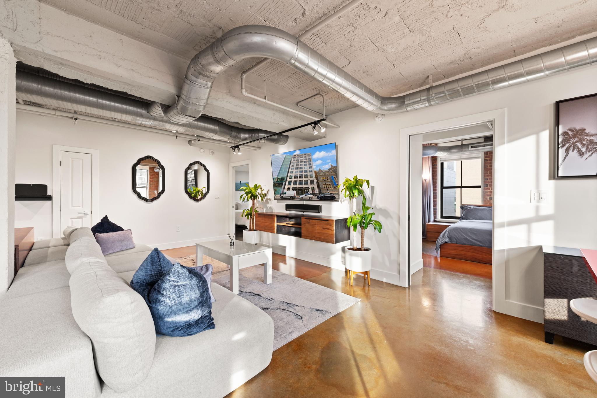 916 G St. Northwest, Unit 903 Washington, DC 20001 - Photo 7 of 65 a living room with furniture and wooden floor