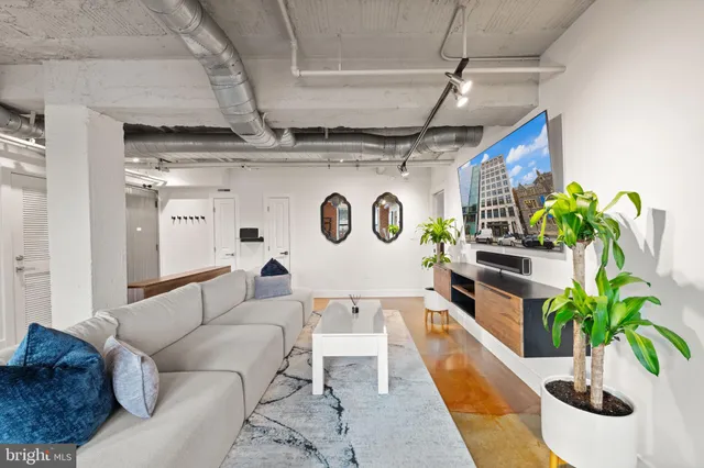 a large kitchen with a large counter top a sink a stove and a refrigerator