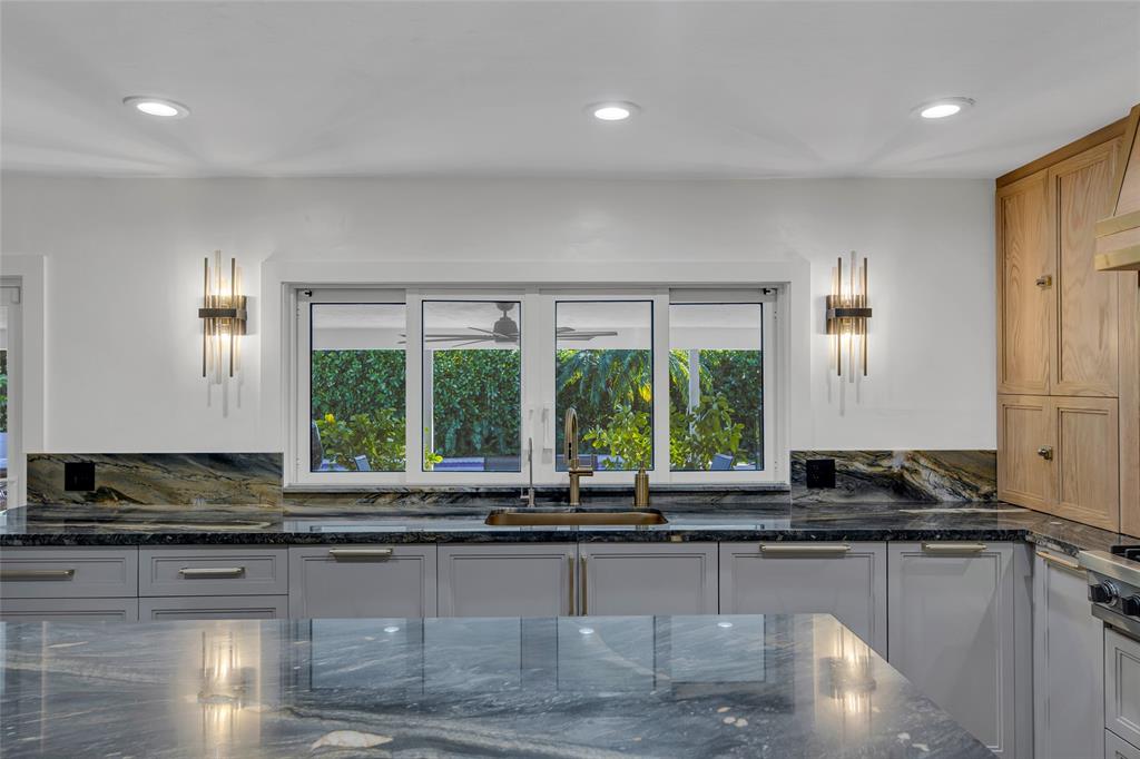 2 Mendota Lane Sea Ranch Lakes, FL 33308 - Photo 26 of 64 a kitchen with a large window appliances and cabinets