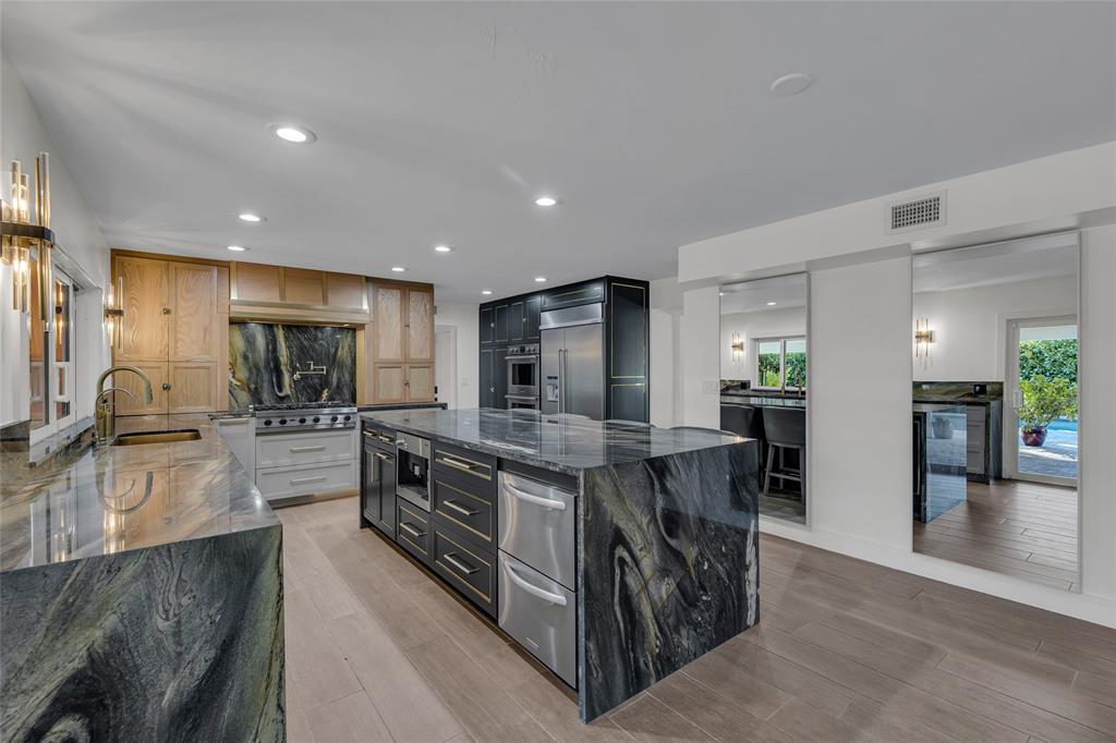 2 Mendota Lane Sea Ranch Lakes, FL 33308 - Photo 31 of 64 a large kitchen with stainless steel appliances lots of counter space and breakfast area