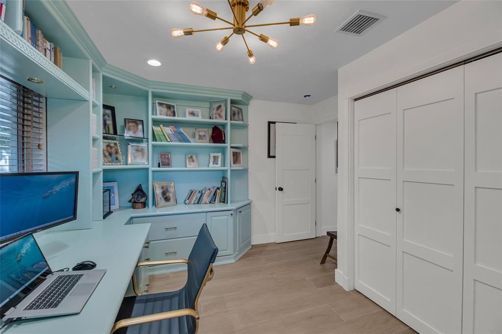 2 Mendota Lane Sea Ranch Lakes, FL 33308 - Photo 43 of 64 a room with furniture a bookshelf and a window