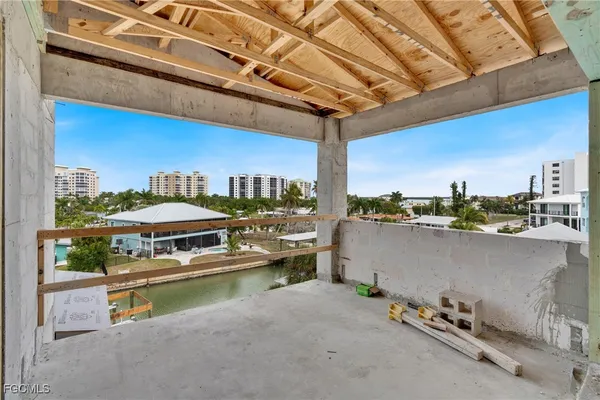a roof deck with table and chairs