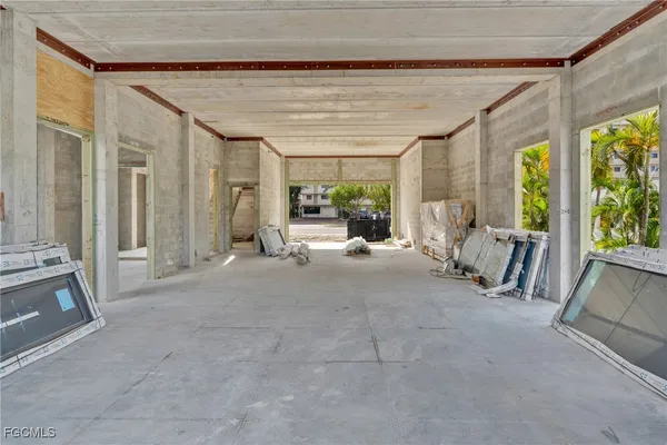 a living room with furniture and large windows