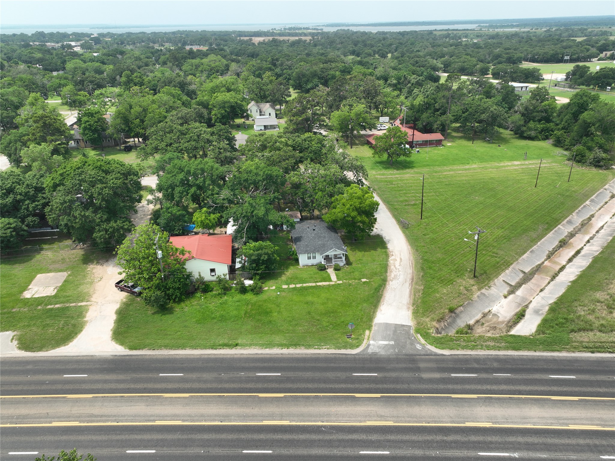 17066 Highway 36 Somerville, TX 77879 - Photo 7 of 16 an aerial view of a house with a yard and lake view